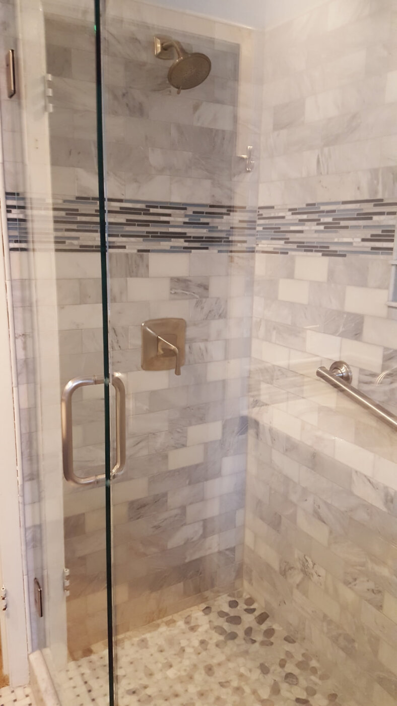 Marble Shower with Glass Mosaic Band by Masterpiece Tile and Grout in the DFW area